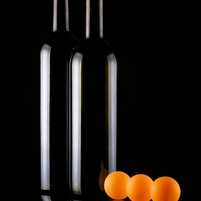 Water bottle and stopwatch on a dark table surface